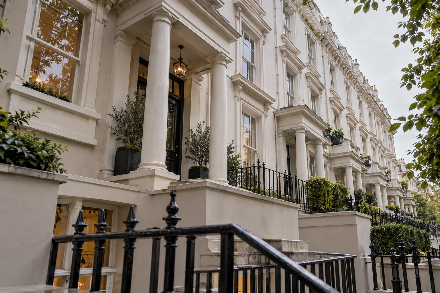 Victorian garden-square terrace with layered stucco details and planted entrance steps